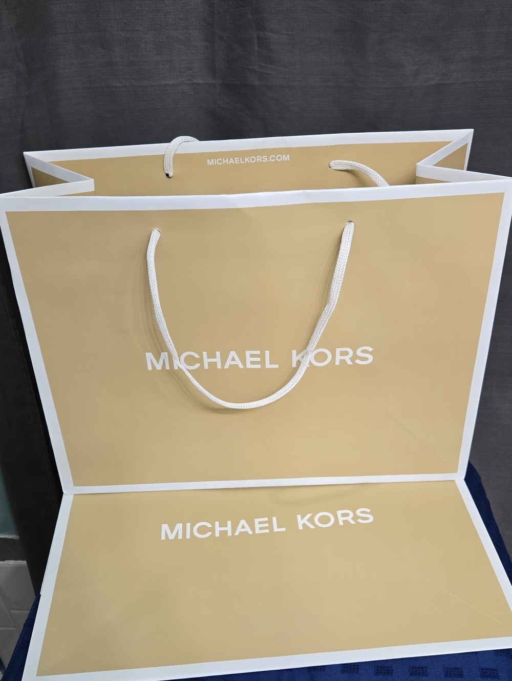 (2) Michael Kors Tan and White Rope-Handle Shopping Bag
